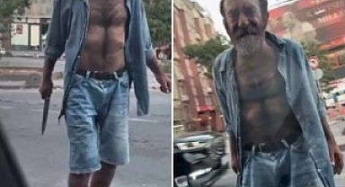 Elinde bıçakla sokakta dolaşan bir şahıs, seyir halindeki aracın camını kırıp küfürler savurdu